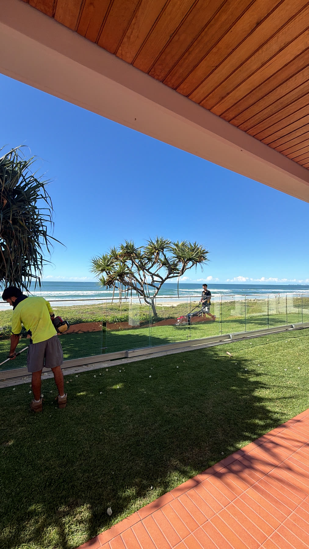 Crew mowing an absolute beachfront lawn